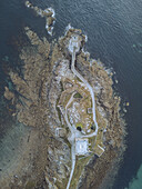 Aerial view of the Kermovan Fort and lighthouse standing proudly against the dark, swirling sea, Le Conquet, Bretagne, France.