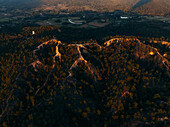 Aerial view of the deep gorges carved into the landscape, casting long shadows and highlighting the canyon's rugged beauty, Pai Canyon, Mae Hi, Thailand.