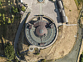 Aerial view of the stark, circular structure contrasts with the surrounding arid landscape, a modern monument standing prominently, Gyumri, Shirak Province, Armenia.