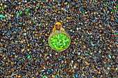 Bogura, Bangladesh - 19 January 2022: Aerial view of a woman amidst a sea of discarded glass bottles, her yellow headscarf a vibrant contrast to the green and brown hues of the recycled materials.