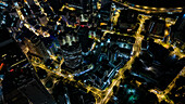 Aerial view of a modern cityscape illuminated with vibrant lights and urban architecture at night, Kuala Lumpur, Federal Territory of Kuala Lumpur, Malaysia.