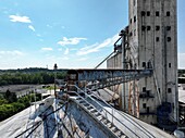 Aerial view of a concrete industrial structure with rusted metal bridge contrasting against the clear blue sky, Cincinnati, Ohio, United States.