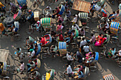 Dhaka, Bangladesh - 13 September 2015: Aerial view of vibrant rickshaws and bustling crowds create a tapestry of color and motion on the city streets.