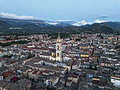 Aerial view of the towering bell tower of the Annunziata complex rises above the sea of terracotta rooftops, nestled against the backdrop of the majestic Apennine Mountains, Sulmona, Abruzzo, Italy.