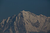 View of the snow-capped mountain peaks piercing the serene blue sky, creating a stunning contrast of cold white and warm blue, Deosai National Park, Gilgit Baltistan, Pakistan.
