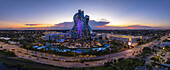Hollywood, Florida, United States - 14 August 2025: Aerial view of the guitar-shaped Hard Rock Hotel, a shimmering beacon against the fading light of dusk.