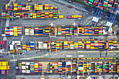 Aerial view of vibrant, stacked shipping containers create a colorful mosaic across the port, a testament to global trade and logistics, Port of La Spezia, Liguria, Italy.