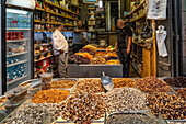 Jerusalem, Israel - 01 November 2019: View of a bustling market scene in Jerusalem, where vibrant displays of nuts and dried fruits entice shoppers under the soft glow of indoor lighting.