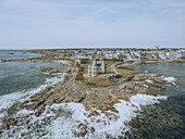 Aerial view of the Château Turpault standing proudly on the rugged Pointe de Beg er Lan peninsula, where the wild Atlantic crashes against the ancient rocks, Quiberon, Brittany, France.