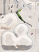 Aerial view of a modern skatepark with its smooth, curving concrete contrasting against the sharp lines of the surrounding architecture, Vilnius, Vilnius, Lithuania.