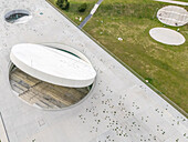 Aerial view of the Science and Innovation Centre's unique circular architecture contrasts starkly with the adjacent green spaces, Kaunas, Kaunas, Lithuania.