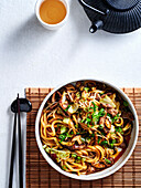 Beef udon stir fry with shiitake, cabbage and sprouts