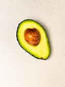 Halved avocado with stone