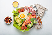 Ketogenic bowl with salmon, avocado and fried egg
