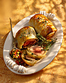 Lamb in pastry crust with olive stock