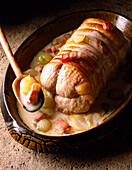 Roast veal roulade wrapped in bacon with a creamy sauce