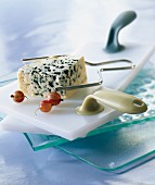 Roquefort on cheese board with slicing wire