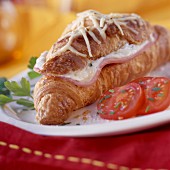 Ham croissant topped with cheese