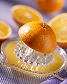 Orangenhälften und Saftpresse