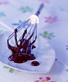 Whisk dipped in melted chocolate