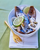 Pickled herrings with spices and lime