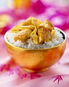 bowl of rice and sautéed curried chicken