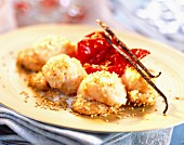 Scallops coated in sesame seeds and preserved tomatoes