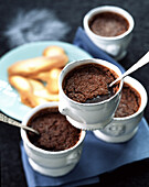 Individual chocolate cream desserts with langues de chat biscuits