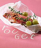 Red mullet with thyme and grapes cooked in wax paper