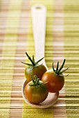 cherry tomatoes on a wooden spoon