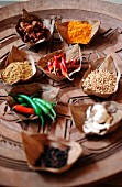 Various spices on a wooden plate