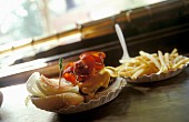 A hamburger and fries on a bar