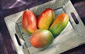 Mangoes on a wooden tray