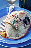 A stuffed crab with corail sauce