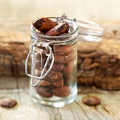 Small glass jar of cocoa beans