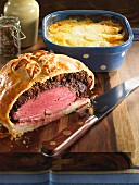 Beef wrapped in puff pastry with gratin dauphinois (traditional French potato gratin)