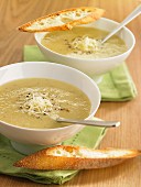 Asparagus soup with pepper and grated cheese