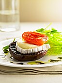 A mushroom, goat's cheese and tomato canapé