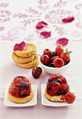 Fruit cakes with berries, cherries and rose petals