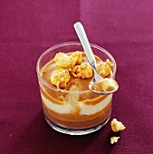 A caramel and popcorn dessert in a glass