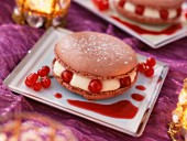 A chocolate macaroon with redcurrants
