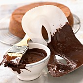A mask being brushed with chocolate