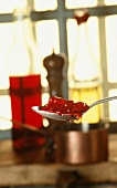 Preparing grand-veneur sauce and a spoonful of redcurrant jelly