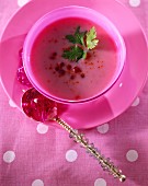 Cream of cauliflower soup with pink pepper