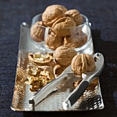 Whole and opened walnuts on a silver tray