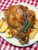 Stuffed roast chicken with apples and potatoes