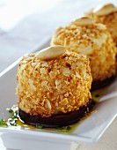 Goat's cheese coated in crushed almonds and stewed eggplants