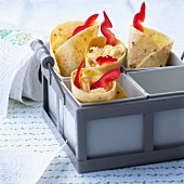 Tacos wraps filled with scrambled eggs ,cheese and sliced red peppers