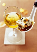 Aperitf spoonful of roquefort ,parmesan,pistachio and apricot puree,glass of white wine