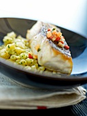 Thick piece of bass with tomatoes and cauliflower